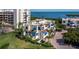 Condo with blue awnings, tropical foliage, and coastal views at 2012 Harbourside Dr # 2104, Longboat Key, FL 34228