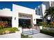 Clubhouse at Fairway Bay with lush landscaping, elegant entrance, and blue accents at 2012 Harbourside Dr # 2104, Longboat Key, FL 34228