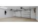Spacious garage with a three-car door, lighting fixtures, and garage door openers at 2012 Harbourside Dr # 2104, Longboat Key, FL 34228