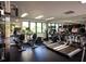 Modern gym featuring treadmills, exercise bikes, and weight machines with large windows overlooking the property at 2012 Harbourside Dr # 2104, Longboat Key, FL 34228