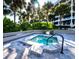 Relaxing hot tub with a stone surround, set among lush greenery and offering a tranquil retreat at 2012 Harbourside Dr # 2104, Longboat Key, FL 34228