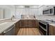 Well-lit kitchen features a modern stainless steel oven, attractive countertops and warm-toned wooden cabinets at 2012 Harbourside Dr # 2104, Longboat Key, FL 34228