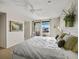 Comfortable main bedroom with a ceiling fan and private balcony access at 2012 Harbourside Dr # 2104, Longboat Key, FL 34228