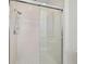Modern bathroom shower with tiled walls, glass door, and rainfall showerhead at 2012 Harbourside Dr # 2104, Longboat Key, FL 34228