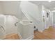 Bright home staircase with white bannister and gray carpet leads up to additional rooms and a shared bathroom at 2012 Harbourside Dr # 2104, Longboat Key, FL 34228