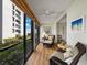 Cozy sunroom with sliding glass doors and wicker furniture at 2012 Harbourside Dr # 2104, Longboat Key, FL 34228