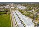 Aerial shot of modern townhomes, highlighting the community's layout near a green space and a commercial area in the distance at 2505 Boone Ct, Sarasota, FL 34237