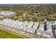 An aerial view displays a series of modern townhomes, featuring neat rows and contemporary designs in a community setting at 2505 Boone Ct, Sarasota, FL 34237