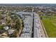 Aerial view of a neighborhood with modern townhomes, parks, and a nearby street at 2505 Boone Ct, Sarasota, FL 34237