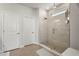 Modern bathroom featuring a glass-enclosed shower and neutral tile flooring at 2505 Boone Ct, Sarasota, FL 34237