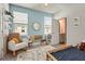 bedroom with blue walls, truck decor, rocking chair and road-themed rug at 2505 Boone Ct, Sarasota, FL 34237