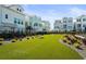 Lush, green common area between townhomes includes comfortable seating and landscaping that encourages neighborly interaction at 2505 Boone Ct, Sarasota, FL 34237