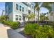Beautiful townhome with a quaint patio featuring lush landscaping and an outdoor dining set at 2505 Boone Ct, Sarasota, FL 34237