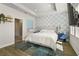 Comfortable main bedroom with stylish blue accents, wood floor, and a view to an ensuite bathroom at 2505 Boone Ct, Sarasota, FL 34237