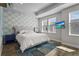 Beautifully decorated main bedroom features a stylish accent wall, recessed lighting, and a mounted TV at 2505 Boone Ct, Sarasota, FL 34237