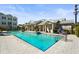 Community pool featuring a fountain, lounge chairs, and building with a white roof and neutral colored pillars at 2505 Boone Ct, Sarasota, FL 34237