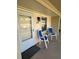 A condo balcony with chairs and a plant, creating an inviting outdoor space at 2607 Woodgate Ln # K9, Sarasota, FL 34231