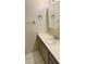 Bathroom sink and vanity with white countertop, cabinet, towel rack, and mirror at 2607 Woodgate Ln # K9, Sarasota, FL 34231