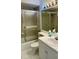 Bathroom featuring a tiled shower with a sliding glass door next to the toilet and sink at 2607 Woodgate Ln # K9, Sarasota, FL 34231