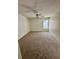 Spacious carpeted bedroom with a ceiling fan and natural light from a window at 2607 Woodgate Ln # K9, Sarasota, FL 34231