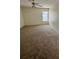 Spacious bedroom with neutral carpet, ceiling fan, and a window for natural light at 2607 Woodgate Ln # K9, Sarasota, FL 34231
