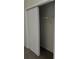 View of carpeted closet with bi-fold doors in a neutral tone and hanging clothes rod at 2607 Woodgate Ln # K9, Sarasota, FL 34231