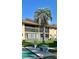 Exterior of condo units with a large palm tree and recreational area at 2607 Woodgate Ln # K9, Sarasota, FL 34231