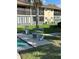 Exterior view of condo buildings with benches and a lush lawn area at 2607 Woodgate Ln # K9, Sarasota, FL 34231