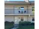 Exterior view of condos with a balcony and well-maintained landscaping at 2607 Woodgate Ln # K9, Sarasota, FL 34231