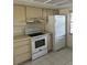 Bright kitchen featuring modern appliances, white cabinetry, and tile flooring for easy maintenance at 2607 Woodgate Ln # K9, Sarasota, FL 34231