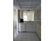 Charming kitchen featuring white cabinets, appliances, and tile flooring for a clean, classic design at 2607 Woodgate Ln # K9, Sarasota, FL 34231