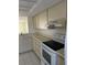Bright kitchen featuring white countertops and a view into the dining area at 2607 Woodgate Ln # K9, Sarasota, FL 34231