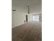 Carpeted living room with a balcony view and mirrored wall accents at 2607 Woodgate Ln # K9, Sarasota, FL 34231