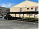Exterior view of covered parking area adjacent to condo buildings at 2607 Woodgate Ln # K9, Sarasota, FL 34231