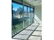 Enclosed sunroom/patio with sliding glass doors offering a serene view of the community pool and lush greenery at 2607 Woodgate Ln # K9, Sarasota, FL 34231