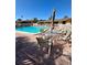 Inviting community pool area with comfortable seating and umbrellas for relaxation and outdoor enjoyment at 2607 Woodgate Ln # K9, Sarasota, FL 34231