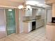 Well-lit kitchen boasting white cabinets, tiled floor, stainless steel sink, and sliding door access at 2712 36Th Avenue E Ter, Bradenton, FL 34208