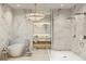 Spacious bathroom with marble walls, a soaking tub, a glass-enclosed shower, and a modern vanity at 290 Cocoanut Ave # 7A, Sarasota, FL 34236