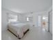 Bedroom with a large bed, mirror and view into the bathroom at 3048 Lockwood Ter, Sarasota, FL 34231