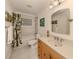 Well-lit bathroom featuring a vanity with sink, toilet, and shower-tub combo at 333 Bayshore Dr, Venice, FL 34285