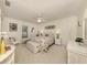 Comfortable bedroom with floral bedding, white wicker furniture, and ample natural light at 333 Bayshore Dr, Venice, FL 34285