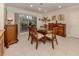 Well-lit dining room with a glass-top table, tropical-themed decor, and sliding glass doors at 333 Bayshore Dr, Venice, FL 34285