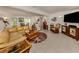 Comfortable living room with a large sectional, tile flooring, and tropical decor at 333 Bayshore Dr, Venice, FL 34285