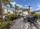 Outdoor patio with a dining table and umbrella amidst lush landscaping, creating an inviting and relaxing space at 333 Bayshore Dr, Venice, FL 34285