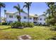 Low angle of a condo building with palm trees, and a well-manicured green lawn at 3803 54Th W Dr # 203, Bradenton, FL 34210