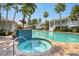 Inviting community hot tub and pool area surrounded by lush landscaping at 3803 54Th W Dr # 203, Bradenton, FL 34210