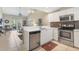 Bright kitchen featuring stainless steel appliances, tile backsplash, and white cabinetry at 3803 54Th W Dr # 203, Bradenton, FL 34210