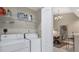Functional laundry room, appliances, and access to the dining area through an open door at 3803 54Th W Dr # 203, Bradenton, FL 34210