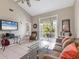 Inviting living room with tile flooring, ceiling fan, and lanai access at 3803 54Th W Dr # 203, Bradenton, FL 34210