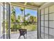 Screened-in patio with tiled floor, providing a relaxing outdoor space surrounded by lush greenery at 3803 54Th W Dr # 203, Bradenton, FL 34210